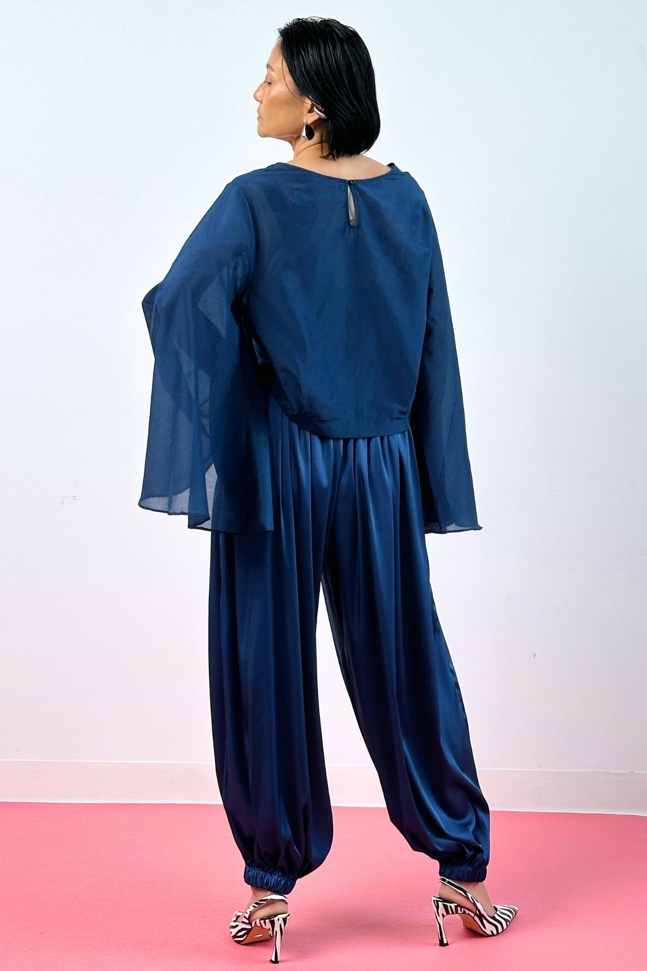 Rear view navy blue silk balloon pants and sheer long sleeve top – women's wide-leg silk trousers full length