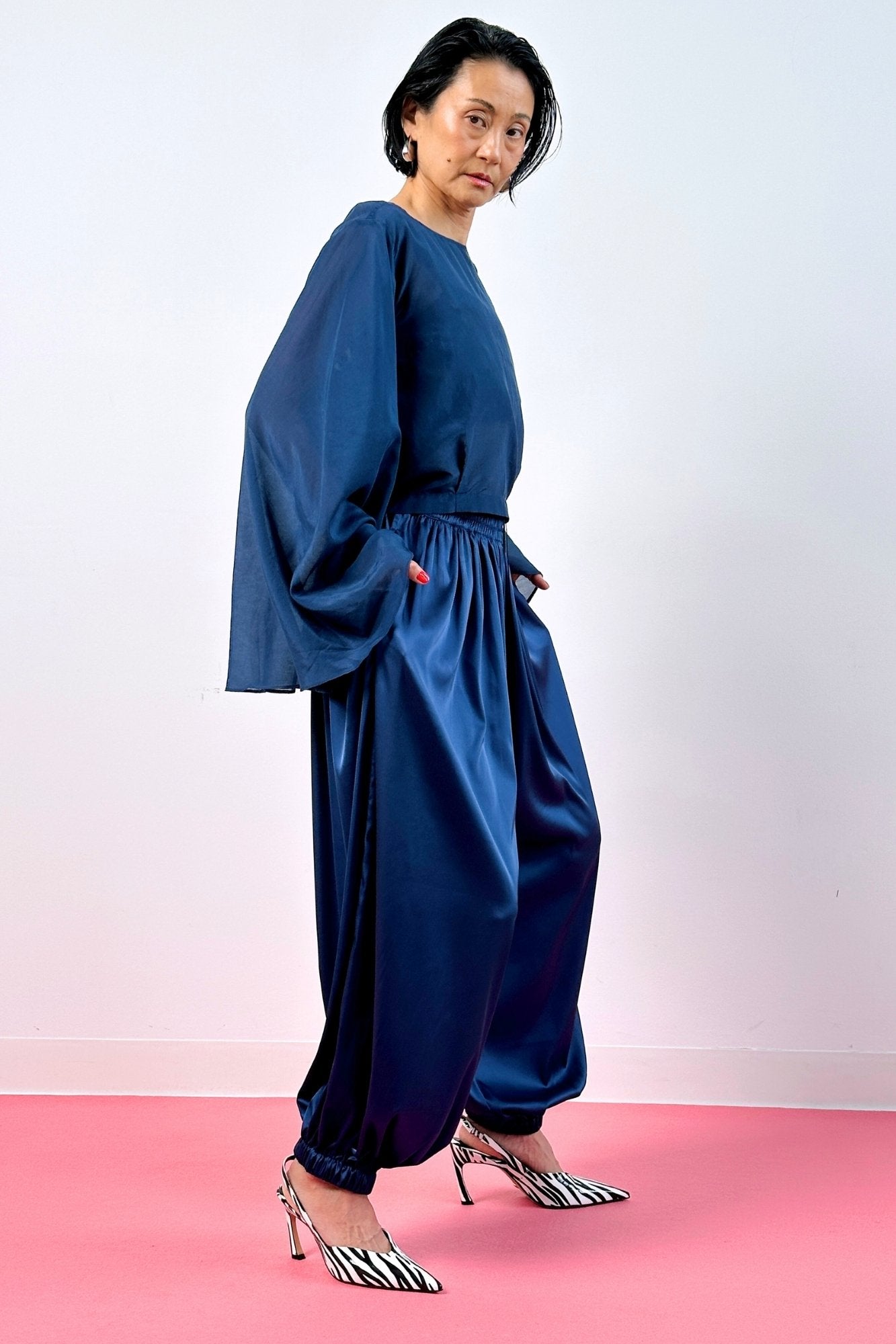 Side view navy blue silk balloon pants and sheer long sleeve top – women's wide-leg silk trousers full length