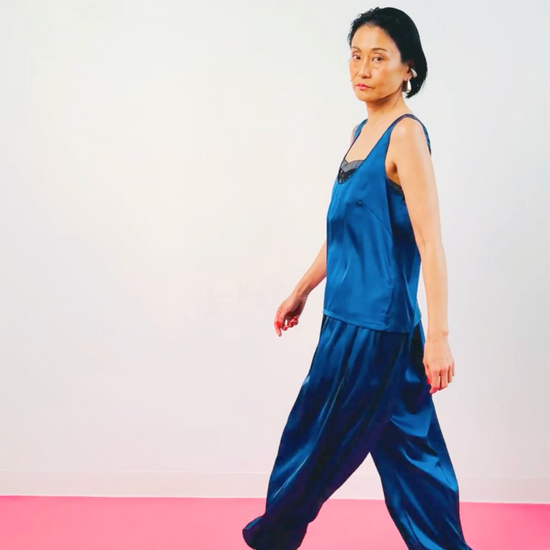 Women's navy blue silk tank top and balloon pants outfit – model walking, full look