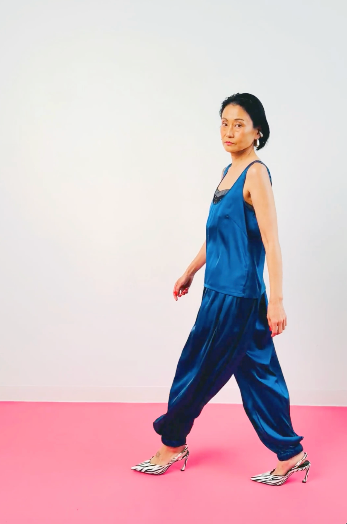 Women's navy blue silk tank top and balloon pants outfit – model walking, full look